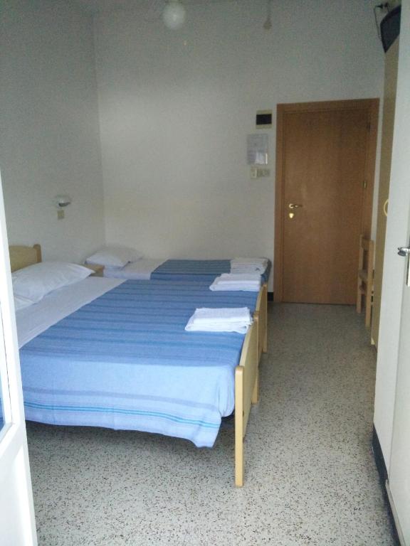 Postel nebo postele na pokoji v ubytování Hotel Ronconi