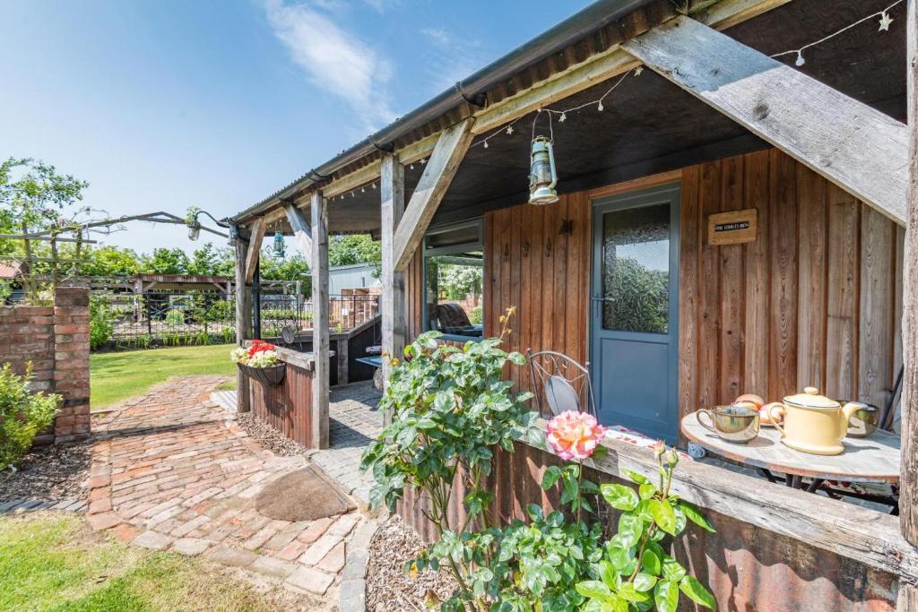 a wooden house with a door and a patio at 2 Bed in Keddington oc-t32411 in Louth