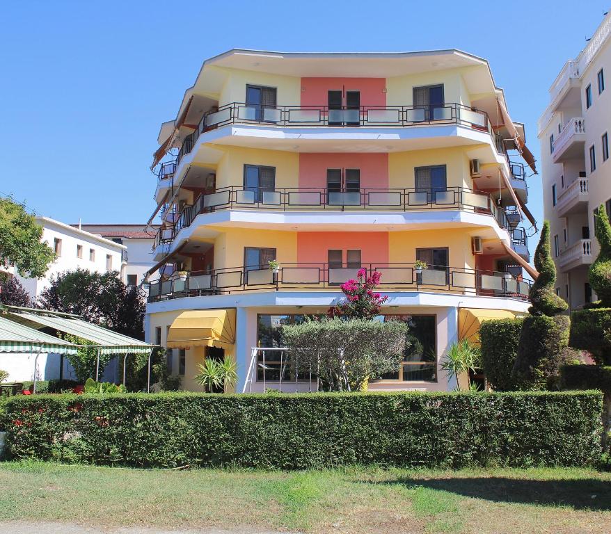 a tall building with balconies on the side of it at Hotel Martini in Velipojë