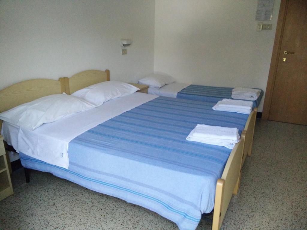 Postel nebo postele na pokoji v ubytování Hotel Ronconi