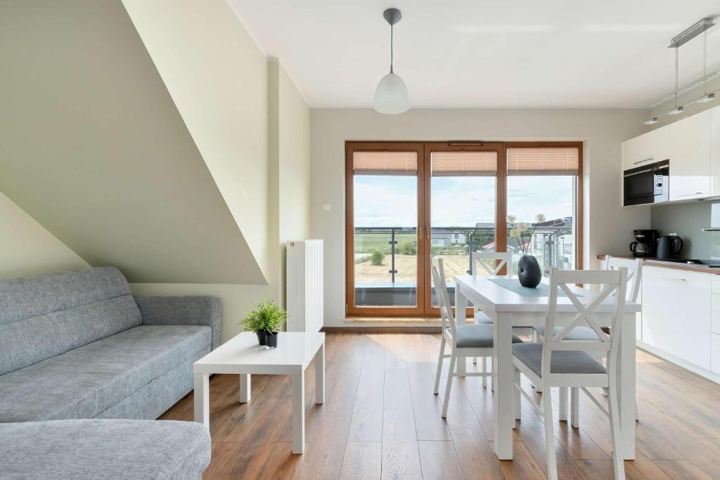 a living room with a couch and a table at Family Apartment Puck Closeto the Sea by Noclegi Renters in Puck