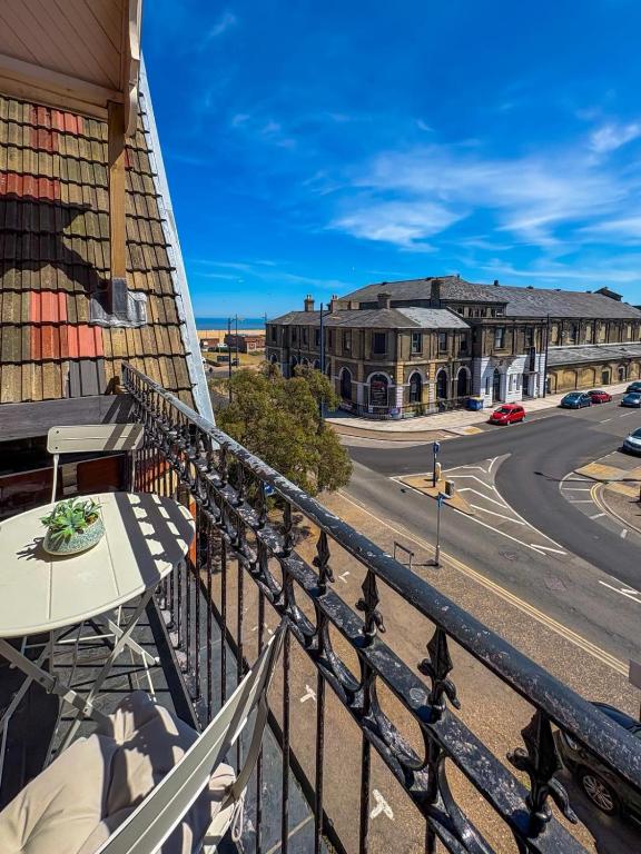 a balcony with a table and a view of a street at Euston Road - Beach Apartment 4 in Great Yarmouth