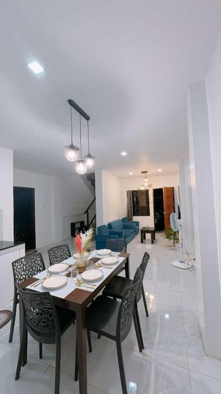 a dining table and chairs in a living room at 2 Storey Family House in Casa Verde Mati City in Mati