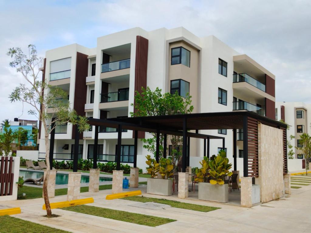 an image of an apartment building with a pool at Prado Suites Las Terrenas in Las Terrenas