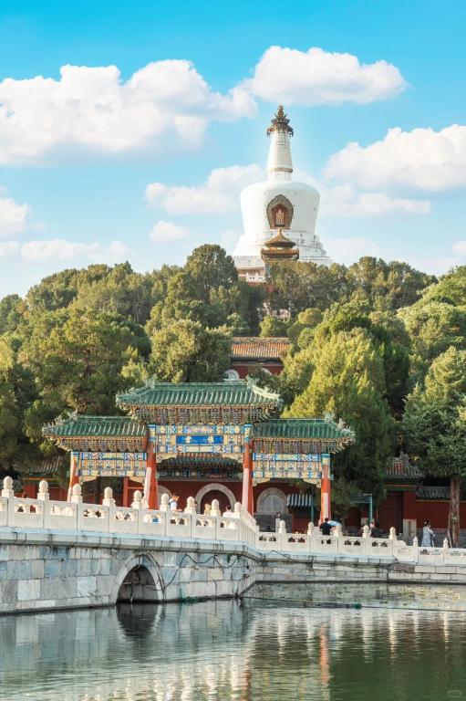 a temple with a bridge and a building with a tower at East Sacred Hotel-Very close to the Drum Tower,The Lama Temple,Houhai Bar Street,Nanluoguxiang,Tiananmen Square and the Forbidden City, and the subway st ation is also very close in Beijing