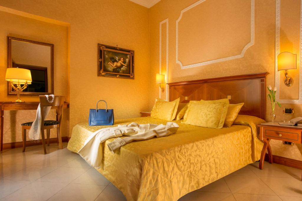 a bedroom with a bed with a blue bag on it at Vatican Amorim in Rome