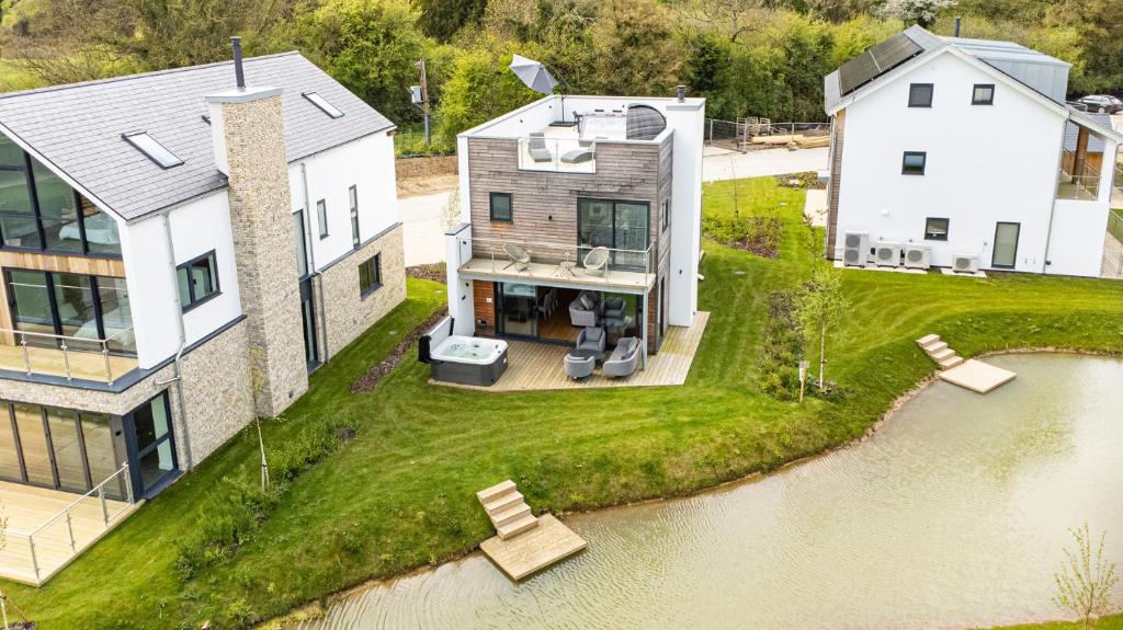 an aerial view of a house and a river at Robins Retreat ML55 Lower Mill Estate Cotswolds in Somerford Keynes