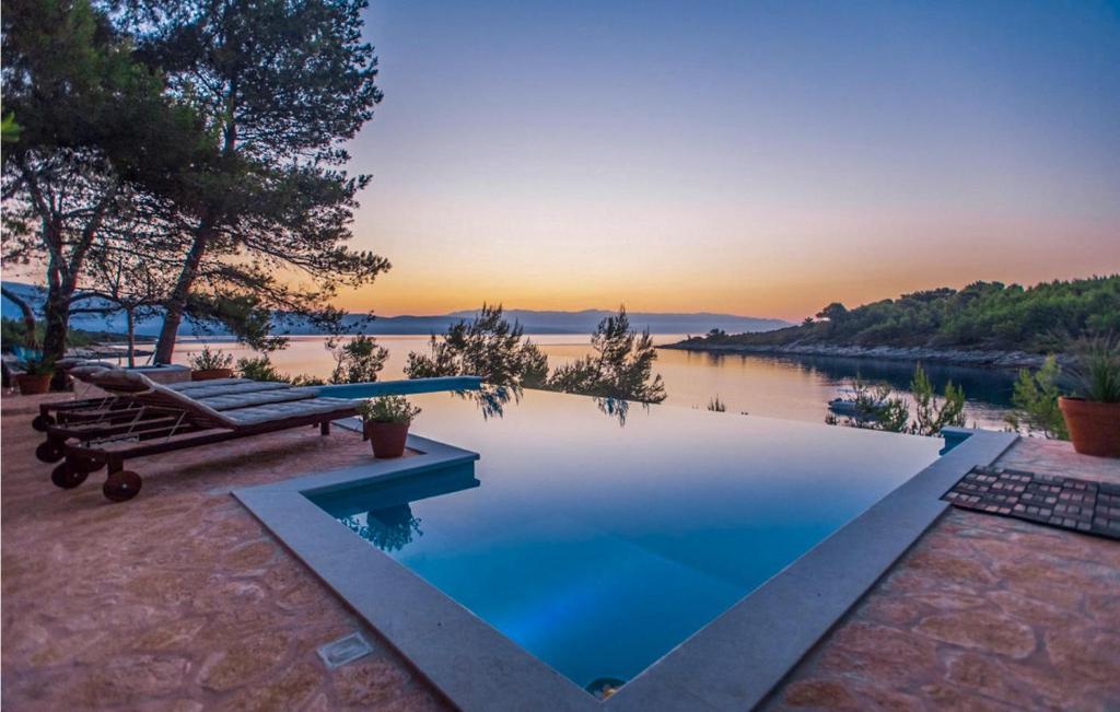 a swimming pool with a view of a body of water at Villa Aqua in Vrbanj