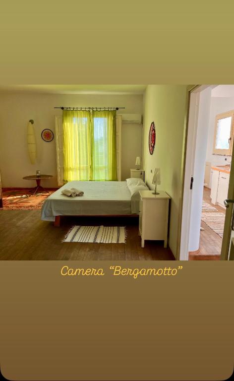 a bedroom with a large bed and a window at Giué in Bovalino Marina