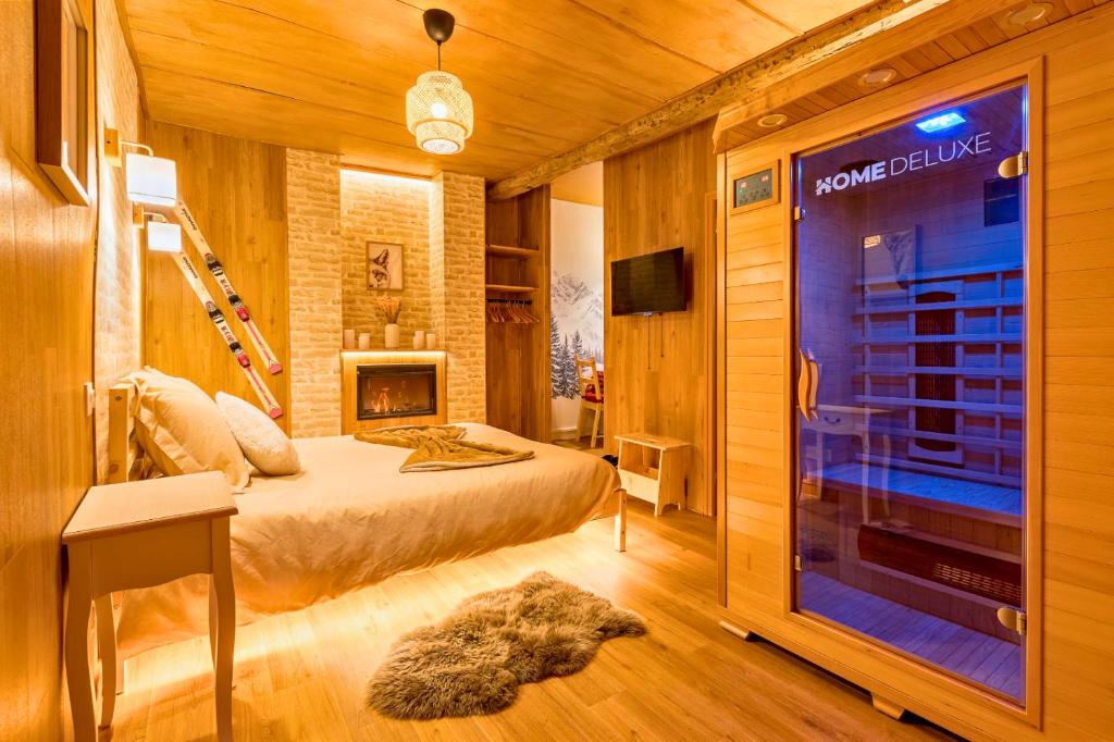 a bedroom with a bed and a large window at L'appart Chalet - Sauna - HyperCentre - Ambiance montagne in Rouen