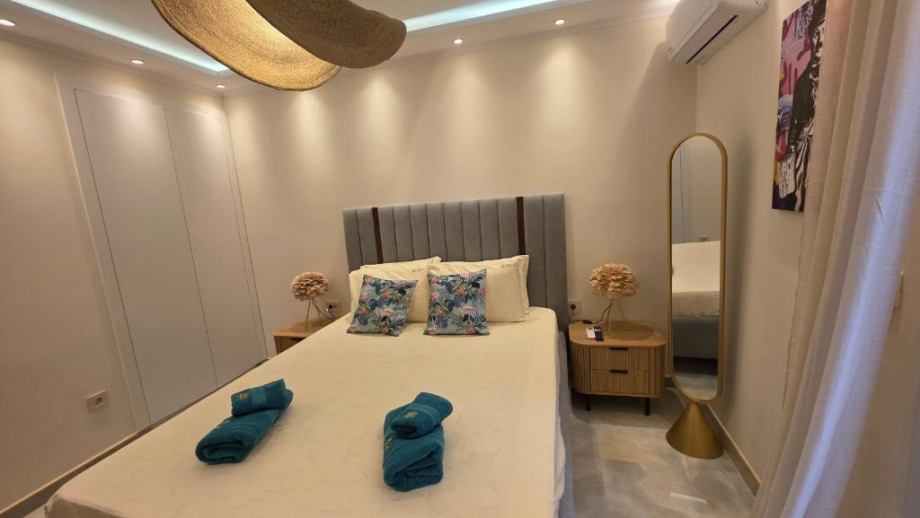 a bedroom with a large bed with blue pillows at Charlie Chaplin luxury apartments in Perea