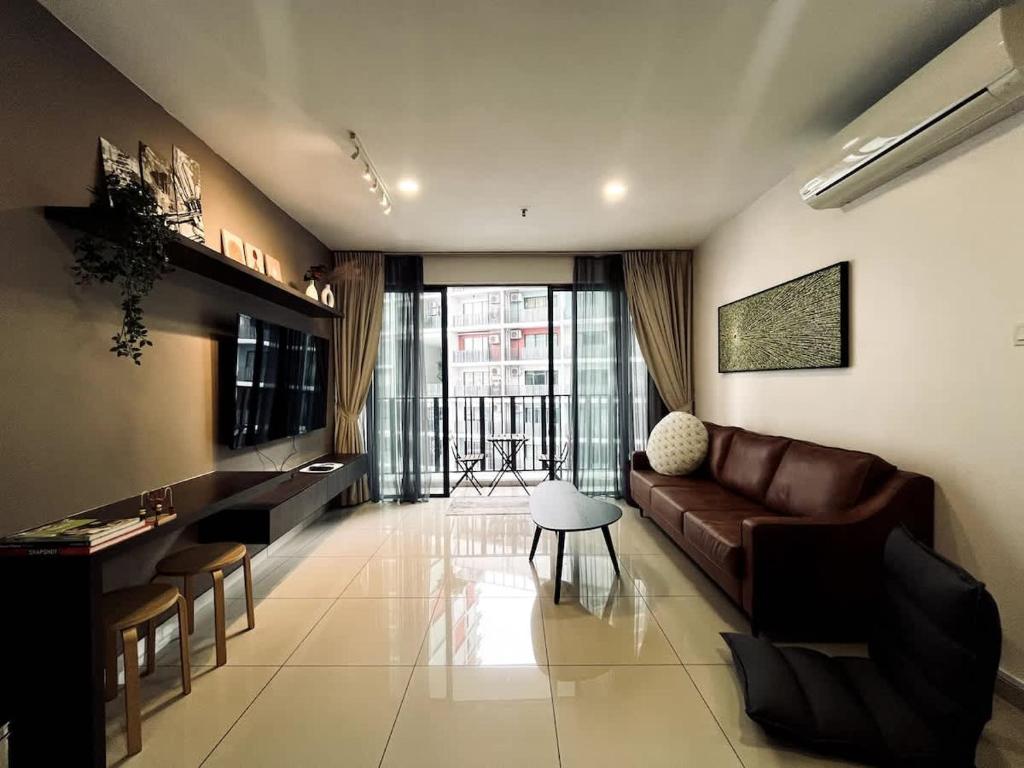 a living room with a couch and a table at Harmony Homes at i-City - free WiFi and 1 Car Park in Shah Alam