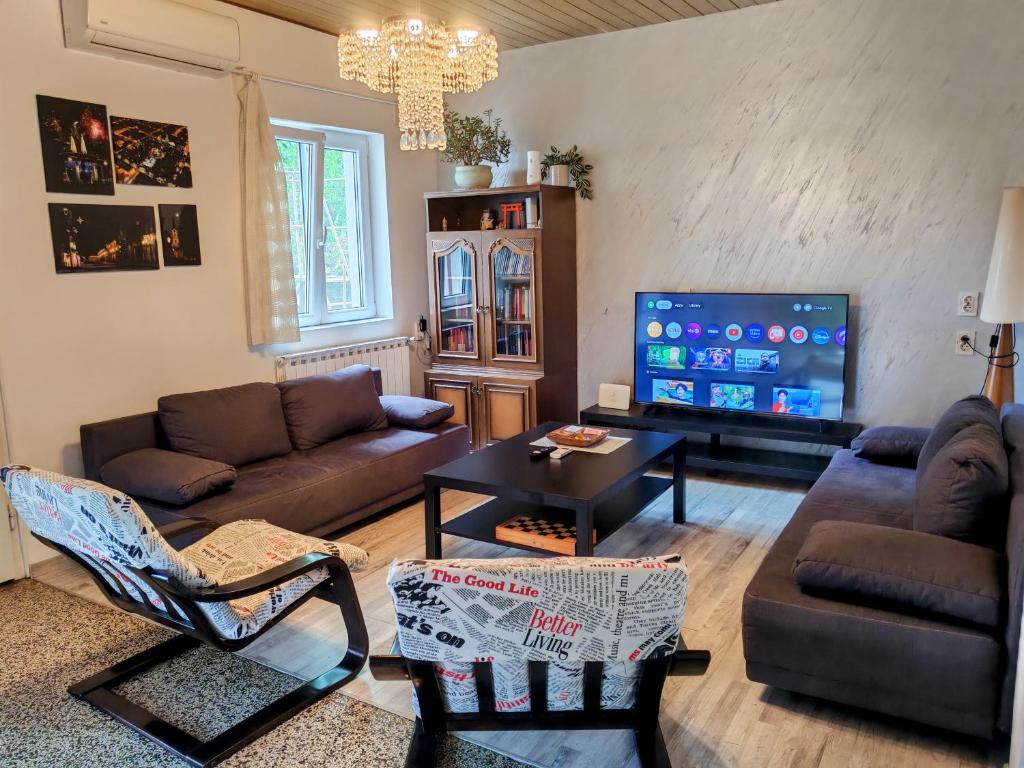 a living room with a couch and a tv at House of Tea in Bjelovar