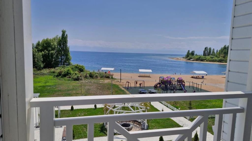 a view of a beach from a balcony at Shaika resort Bibllan apartmens in Chon-Sary-Oy