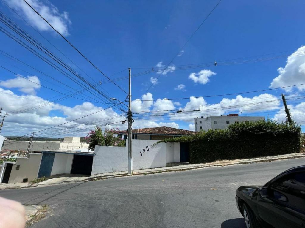 an empty street with a car parked on the road at Suíte Comfort 1 in Garanhuns