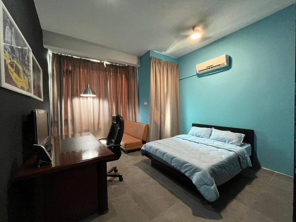 a bedroom with a bed and a desk and a desk at Comfy Empire Damansara Studio in Petaling Jaya