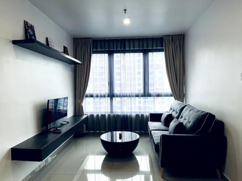 a living room with a couch and a coffee table at Lumi Homes at i-City - WiFi TV Box 1 Carpark in Shah Alam