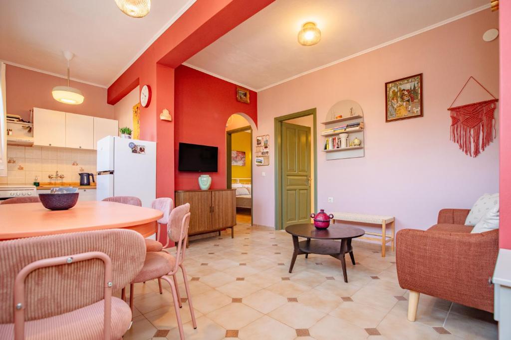a kitchen and living room with a table and chairs at Yiayia's Guesthouse in Ýpsos