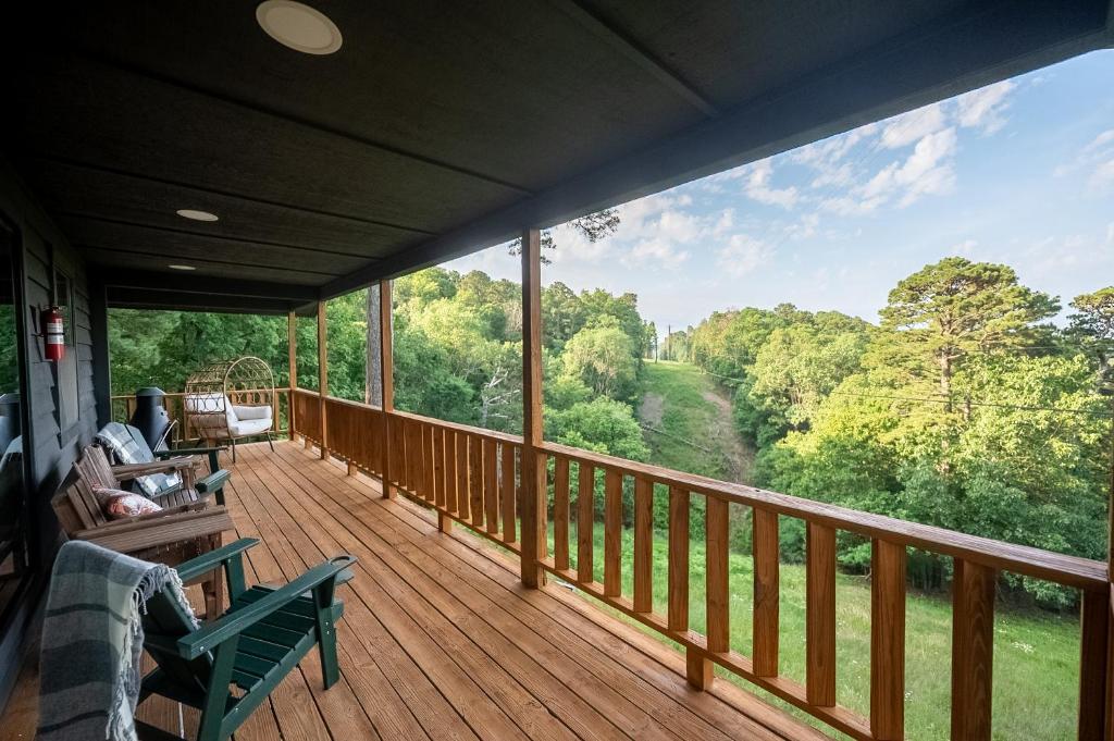 a large deck with a view of the woods at The Woodsman Lodge in Eureka Springs