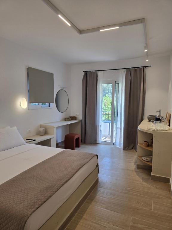 a bedroom with a bed and a sliding glass door at Pension Zoi Luxury Room in Kolymbia