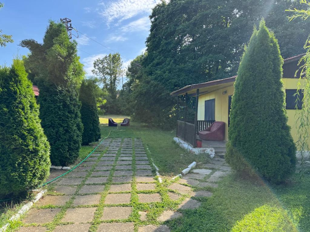 a garden with a stone path leading to a house at Морска База Венера in Tsarevo