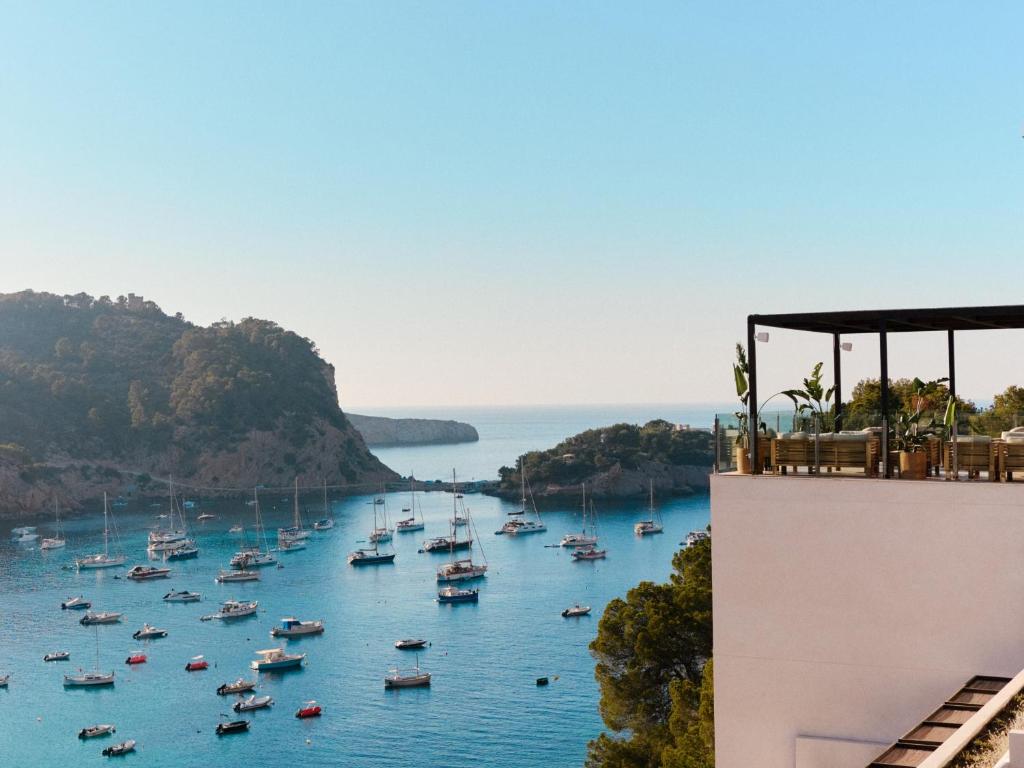 a view of a harbor with boats in the water at Cala San Miguel Ibiza Resort, Adults only, Curio Collection by Hilton in Puerto de San Miguel