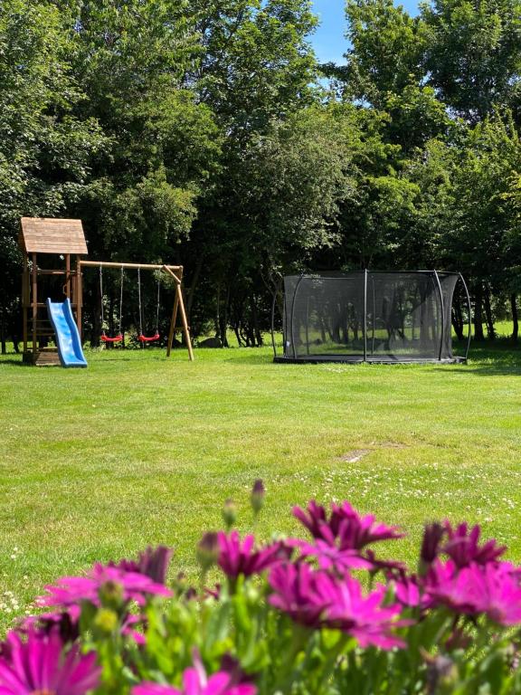 a park with a soccer goal and flowers at Family Retreat Near Billund & Legoland 1 in Billund