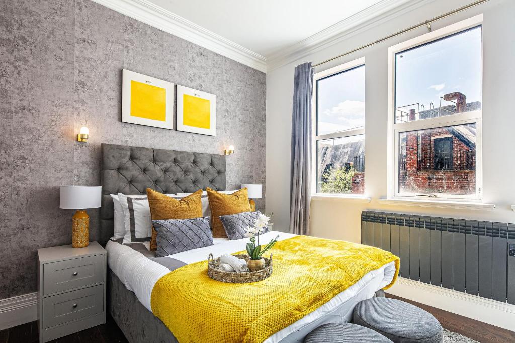 a bedroom with a bed with a yellow blanket at Spacious High End 3-Bedroom Apartment Sleeps 6 in Midland