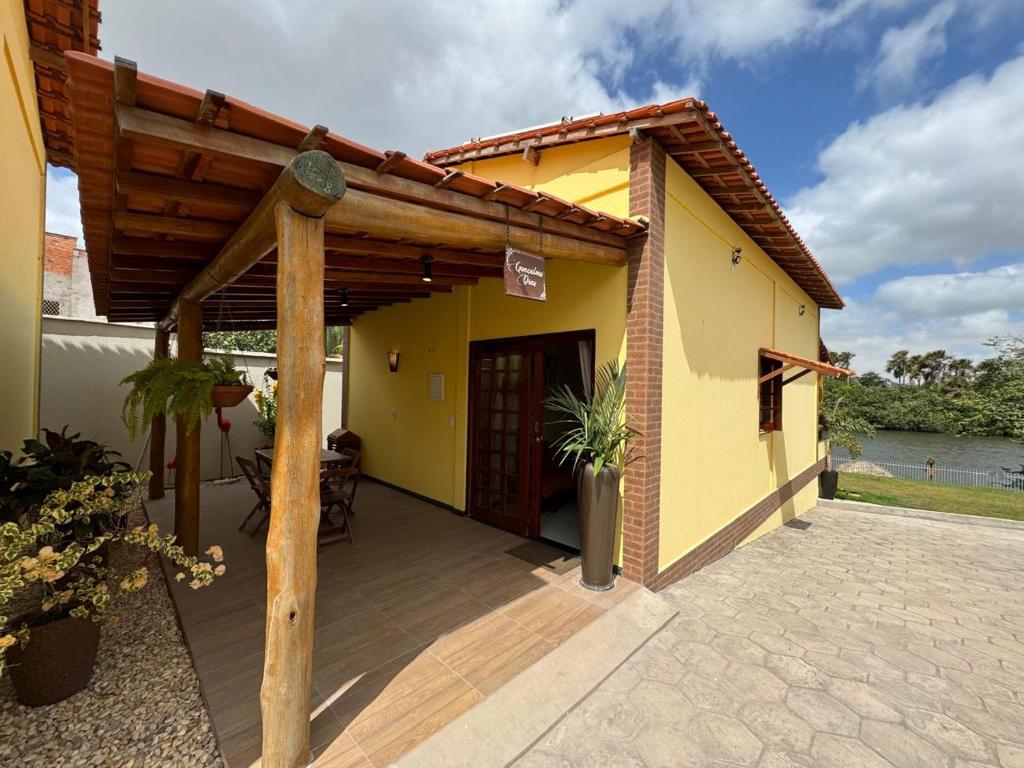 a patio of a house with a wooden porch at Vila dos Poetas - 02 quartos - GD in Barreirinhas