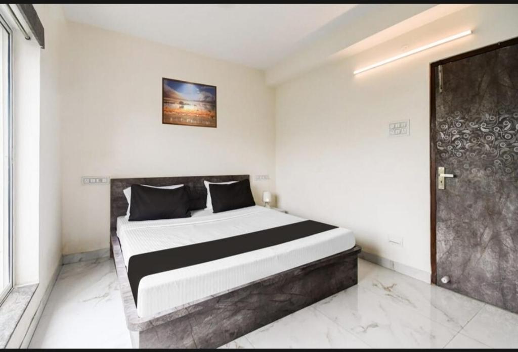 a bedroom with a bed and a door in it at Bluestone Residence in Pānchuria