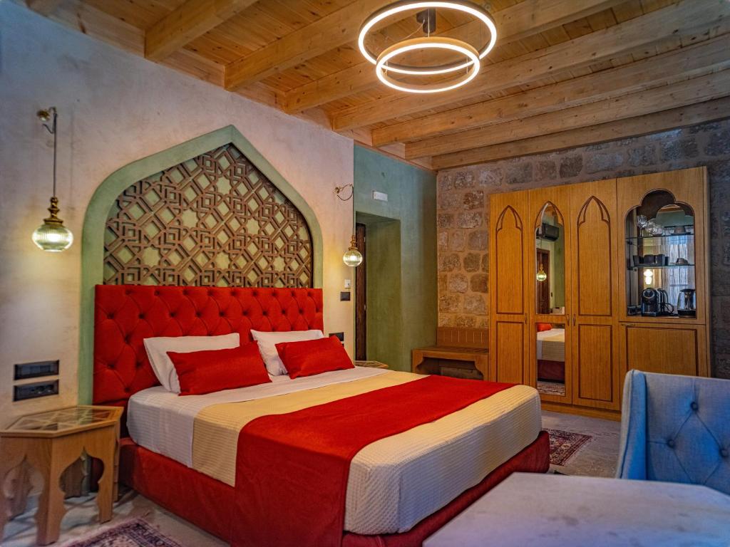 a bedroom with a large bed with a red headboard at Fabrizio del Carretto in Rhodes Town