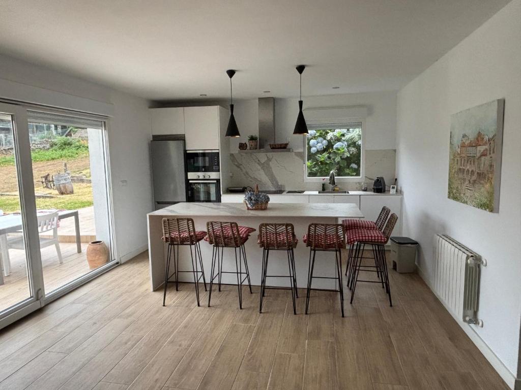 a kitchen with a island with bar stools at Casa Conde in Pontevedra