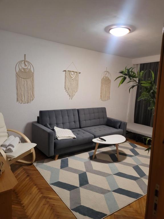 a living room with a couch and a table at La Mare Apartments - 25 in Constanţa