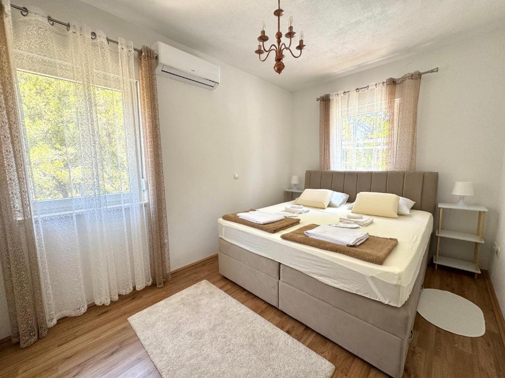 a bedroom with a bed and a large window at Villa Sunshine in Orebić