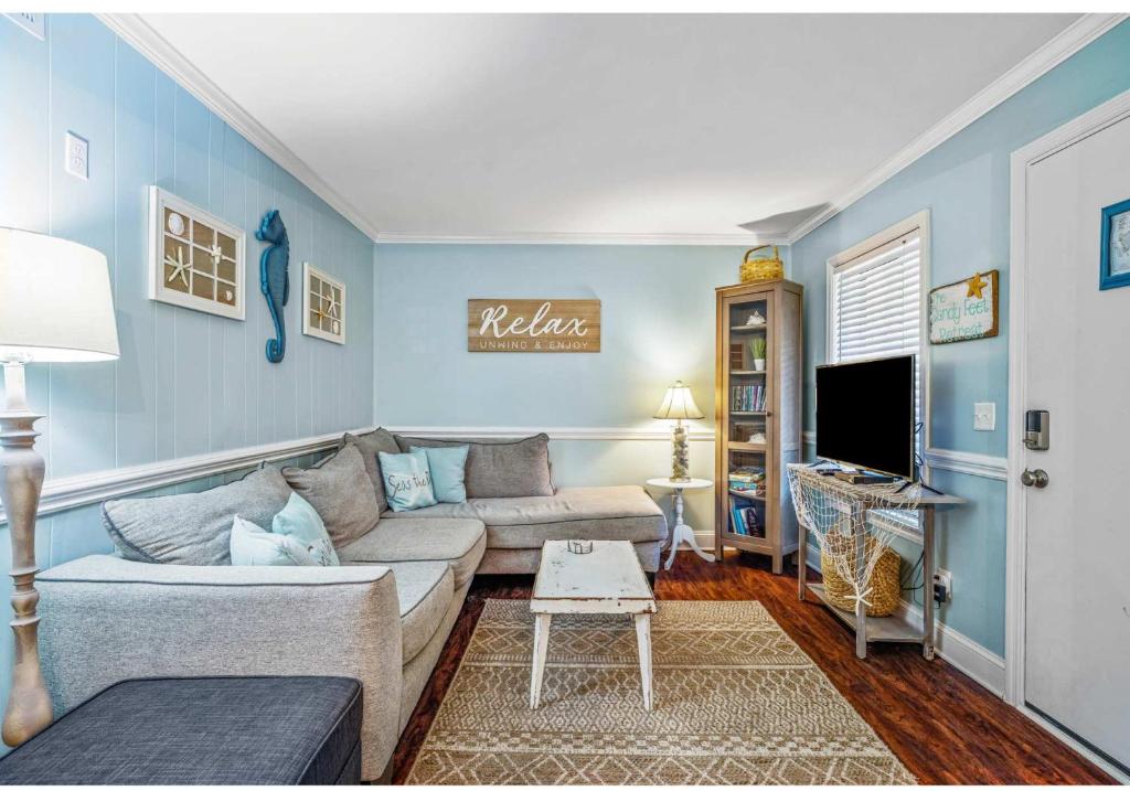 a living room with a couch and a tv at Relaxing Condo for 6 in Popular Hilton Head Resort in Hilton Head Island