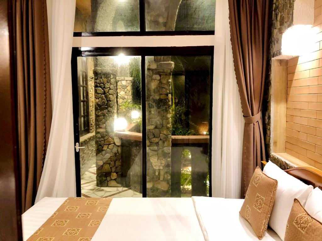Giường trong phòng chung tại Sầm Sơn Boutique Hotel Phan Thiết
