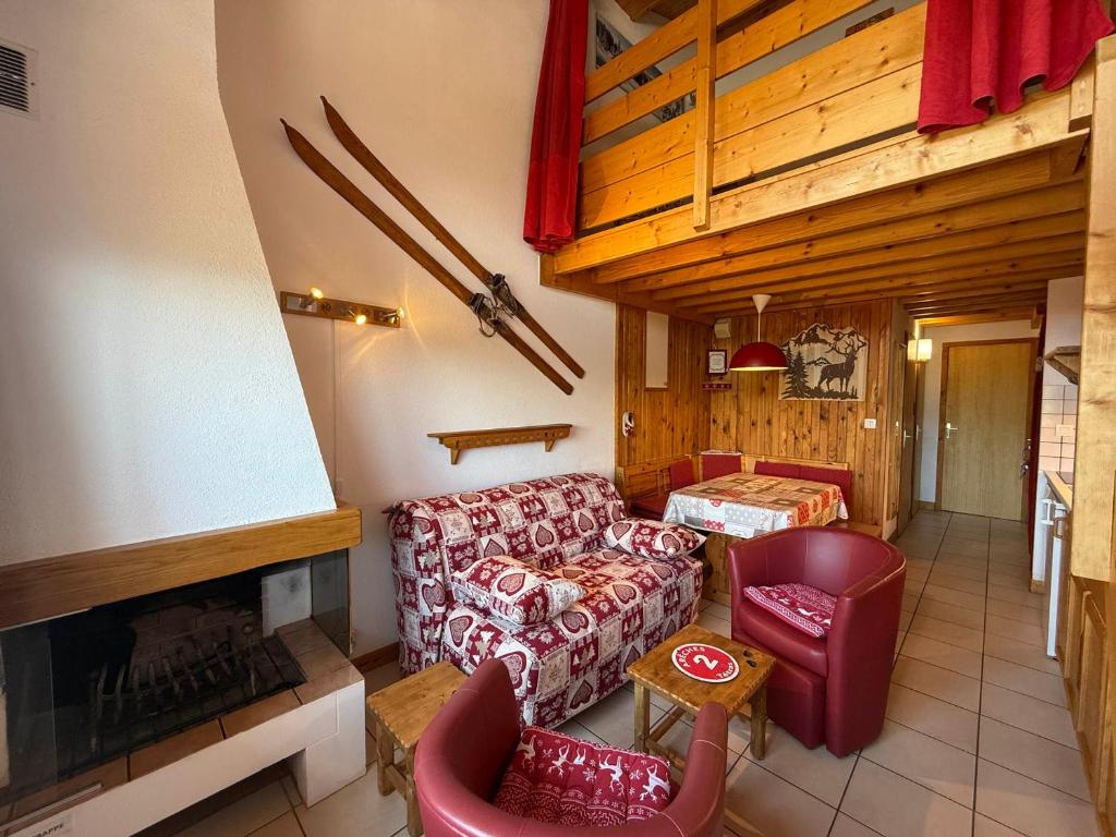 a living room with a couch and a fireplace at Les Saisies Appartement 3 Pièces 8 Pers. avec 2 SDB et Garage - FR-1-293-275 in Hauteluce