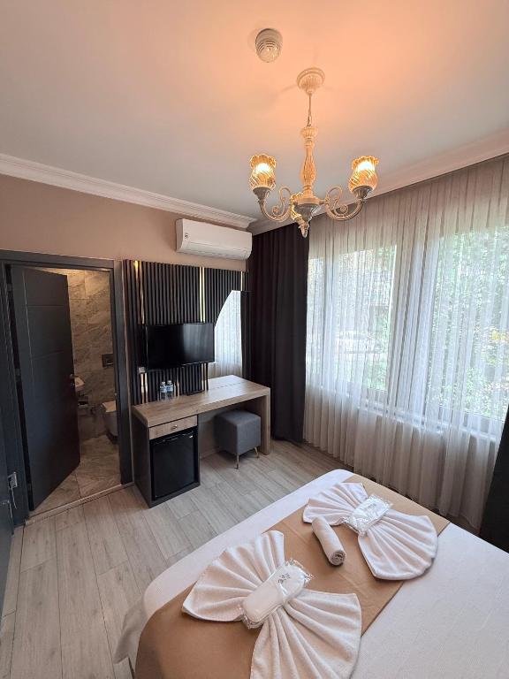 a bedroom with a bed and a chandelier at New Taksim Hotel in Istanbul
