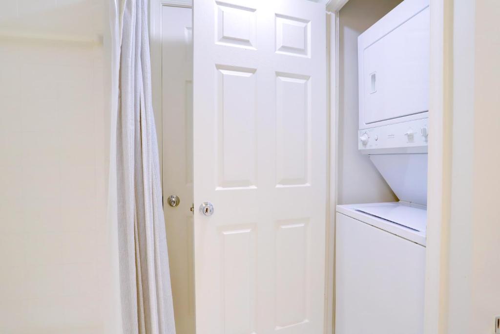 a white door in a kitchen next to a dishwasher at Top Location in Ballston - Pool & Gym Access in Arlington