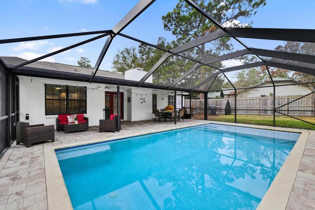 a swimming pool with a pergola over it at Sunnyside Retreat, Private pool, Bluewater Bay, Sleeps 11, Fenced Yard in Niceville