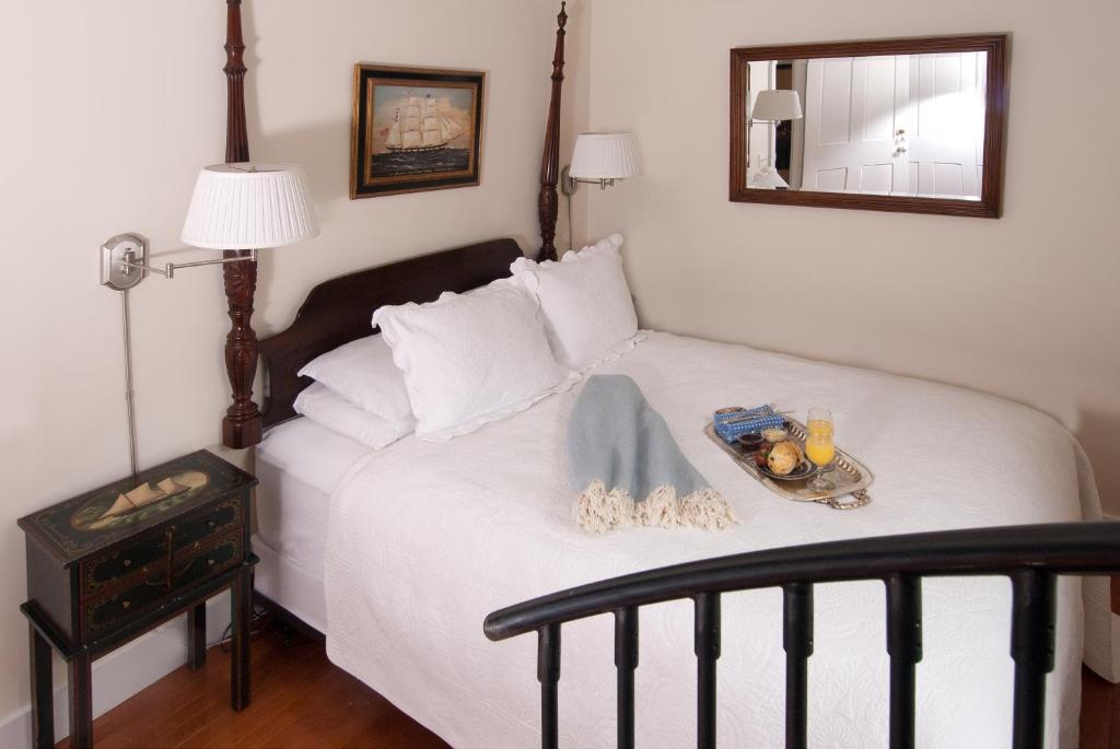a bedroom with a bed with a tray of food on it at Marshall Slocum Inn in Newport