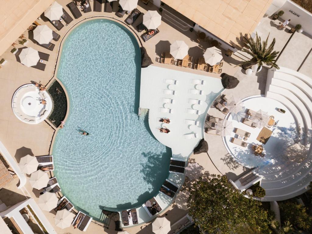 an overhead view of a swimming pool at a resort at AMĀRIA Beach Resort by NOMÉE Hospitality Group in Kamari