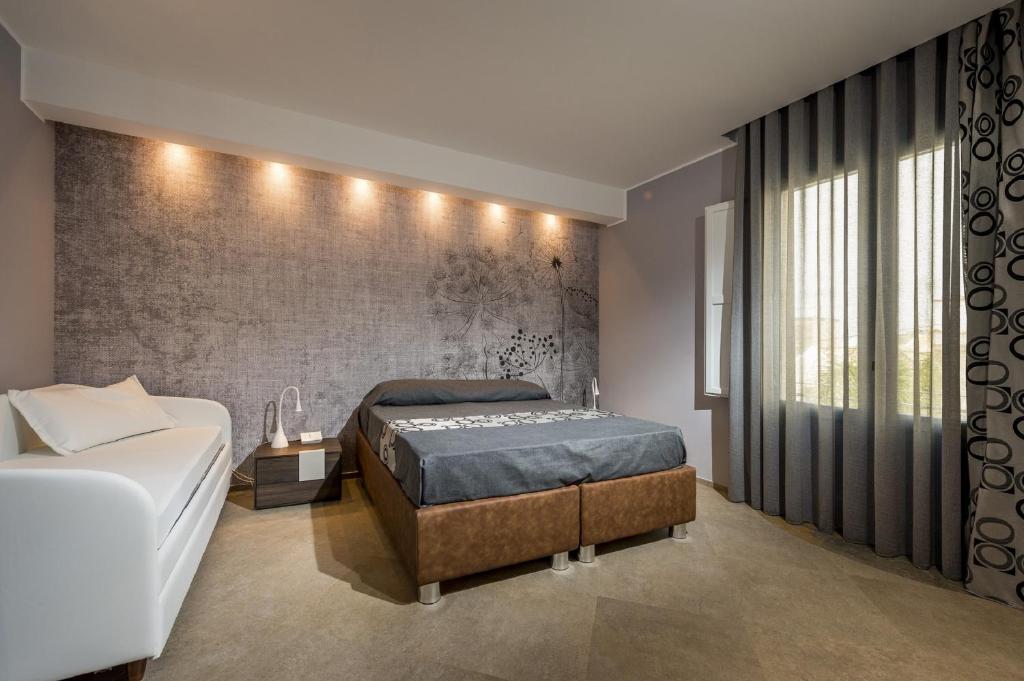 A bed or beds in a room at Hotel Vento del Sud