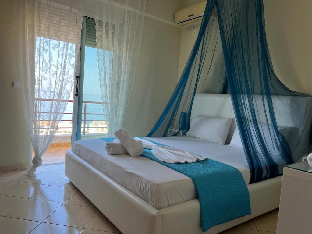 a bedroom with a bed with a canopy at Apartment Katherina Sarande in Sarandë