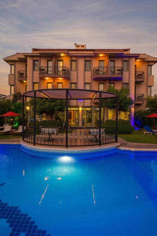 a hotel with a pool in front of a building at Golden Moon Hotel in Fethiye