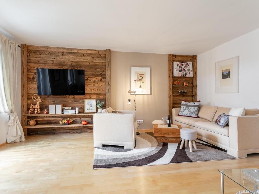 a living room with a couch and a tv at Valerie in Kitzbühel