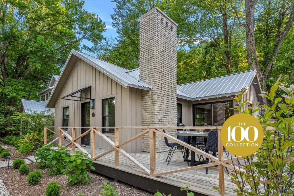 a tiny house with a deck and a chimney at Townie 3 - The Moss in Union Pier