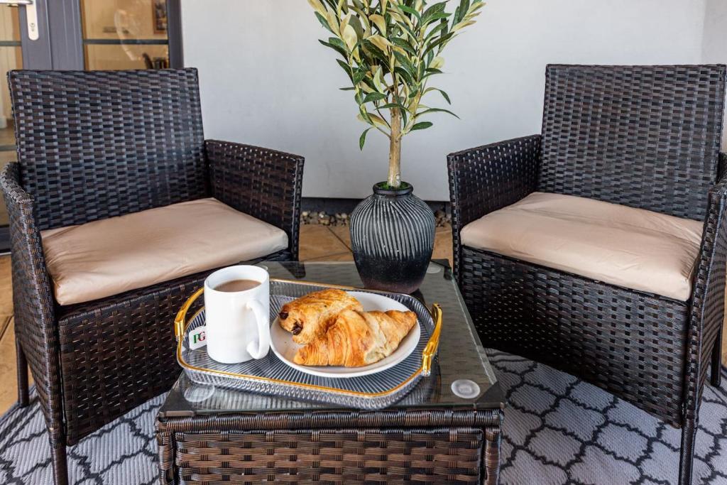 a dog on a plate on a table with two chairs at 2 Bed Oasis London Flat-O2-Excel-Canary Wharf- Shops- Trains -Free Parking,Wifi 500mb & Flex Check In in Woolwich