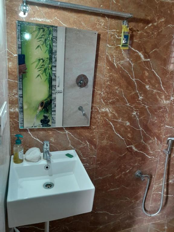 a bathroom with a white sink and a mirror at 1st Floor 2Rooms 6Beds Private Stay in Jāmb