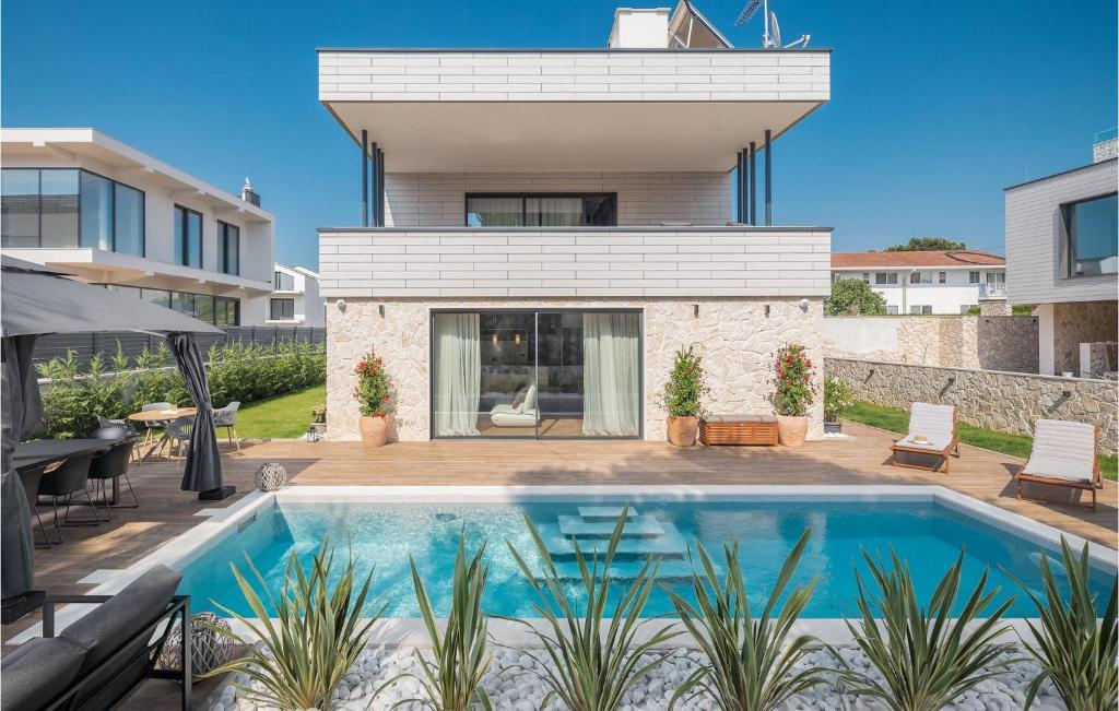 a house with a swimming pool in the backyard at Villa Golden Shine in Poreč